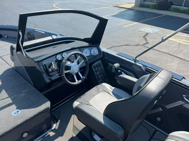Slide: The Image of 2025 Lund 202 Pro-V GL boat interior with steering wheel and dashboard controls. - 15
