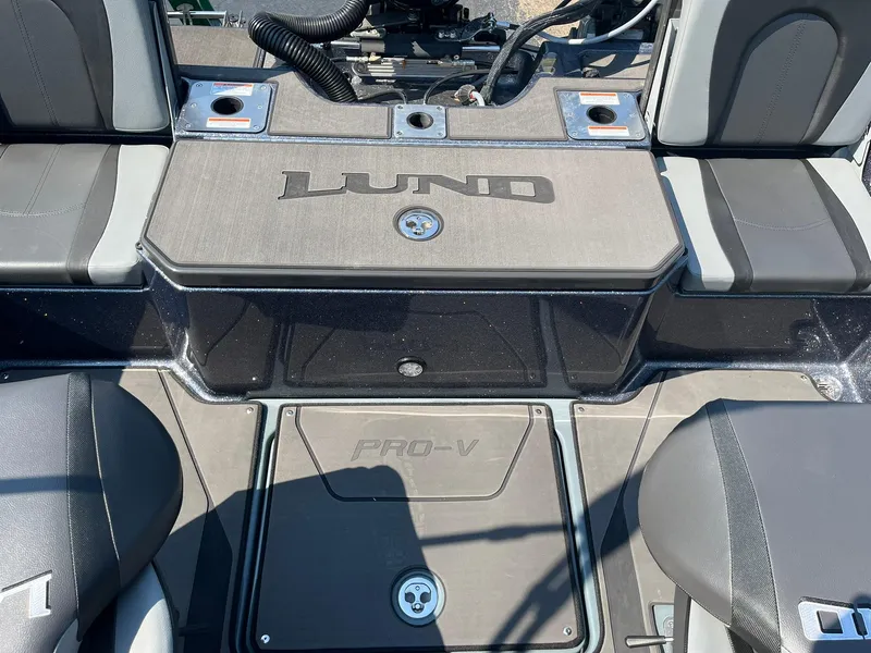 Slide: The Image of 2025 Lund 202 Pro-V GL boat interior with seating and storage compartments. - 17