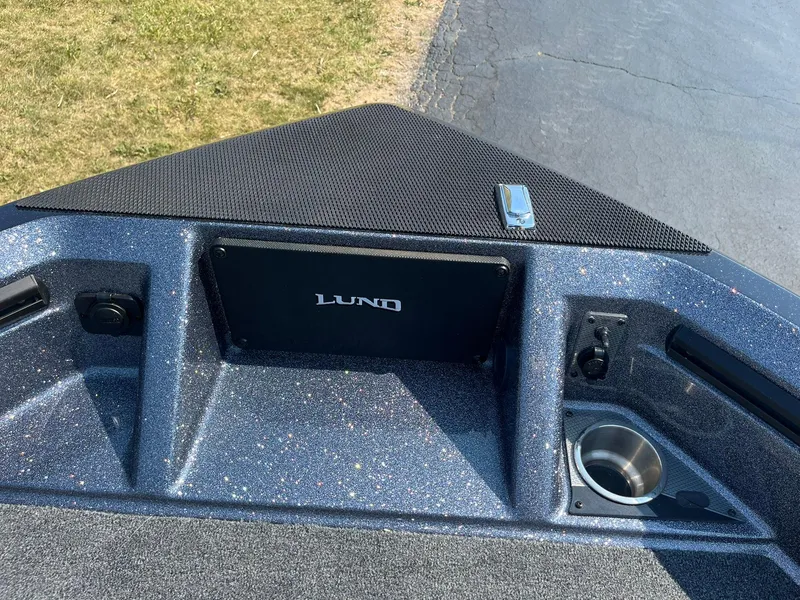 Slide: The Image of 2025 Lund 202 Pro-V GL boat interior with cup holder and storage compartments. - 19