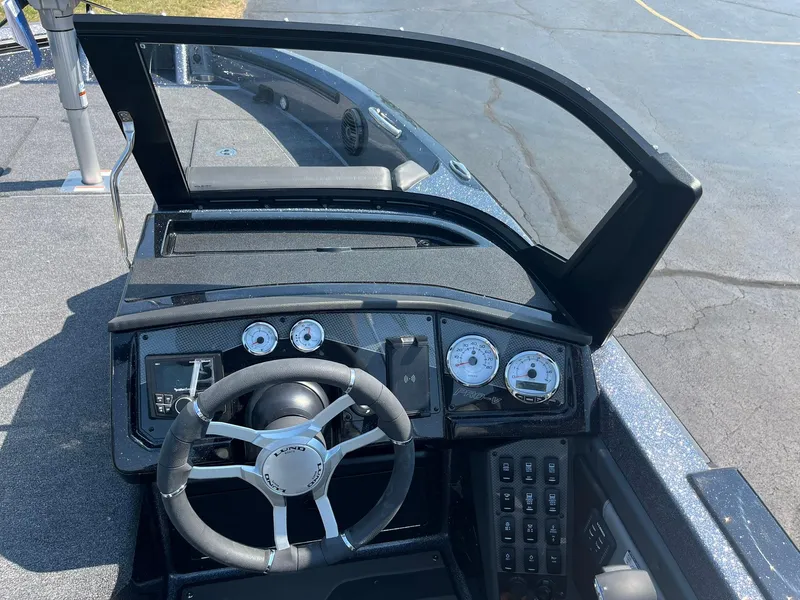 Slide: The Image of 2025 Lund 202 Pro-V GL boat dashboard with steering wheel and gauges. - 20
