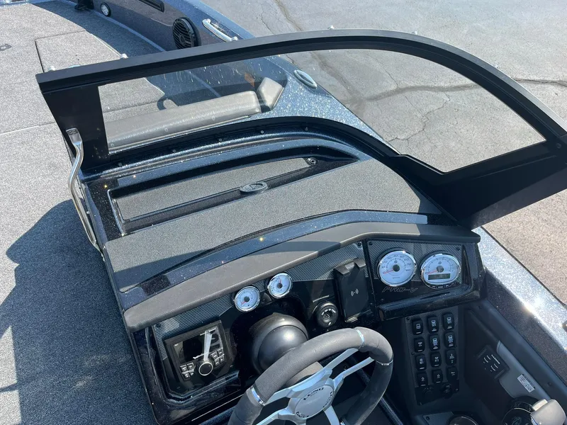 Slide: The Image of 2025 Lund 202 Pro-V GL boat dashboard with steering wheel and instrument panel. - 21