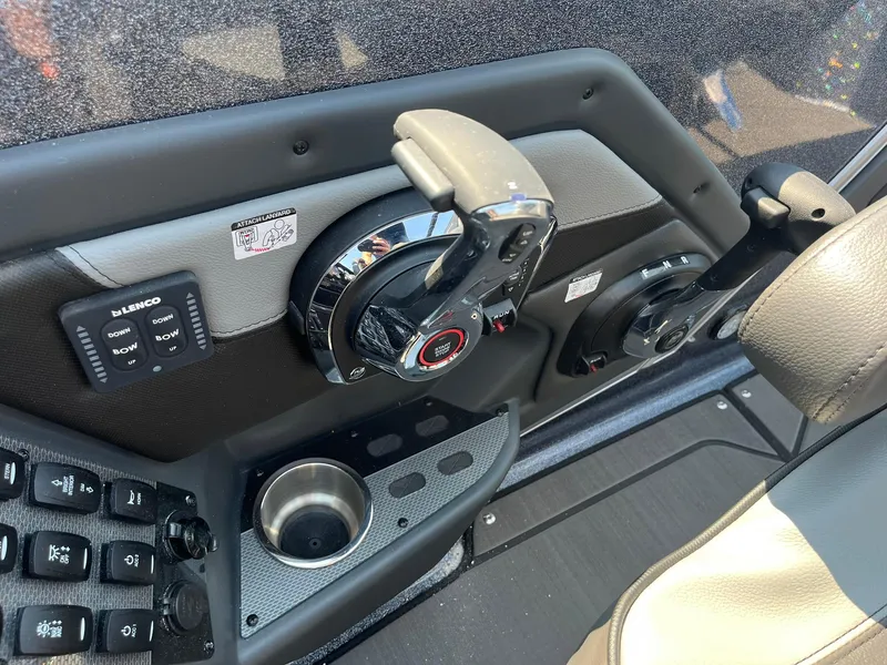 Slide: The Image of 2025 Lund 202 Pro-V GL boat dashboard with controls and cup holder. - 22