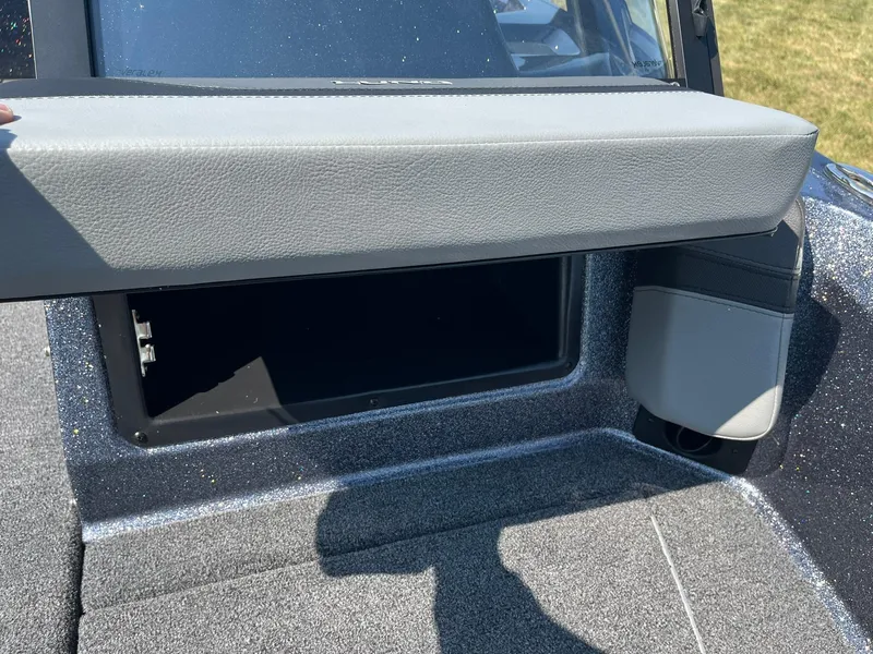 Slide: The Image of 2025 Lund 202 Pro-V GL boat storage compartment with open lid, showcasing interior space. - 29