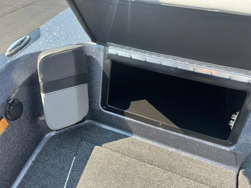Slide: The Image of 2025 Lund 202 Pro-V GL boat storage compartment with open lid, showcasing interior space. - 30