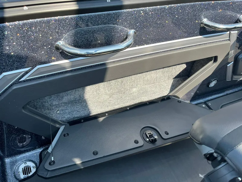 Slide: The Image of 2025 Lund 202 Pro-V GL boat interior storage compartment with sleek design and metallic finish. - 35