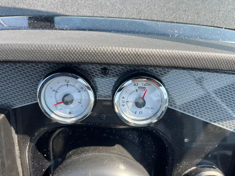 Slide: The Image of Dashboard gauges of 2025 Lund 202 Pro-V GL boat, showing fuel and trim levels. - 36