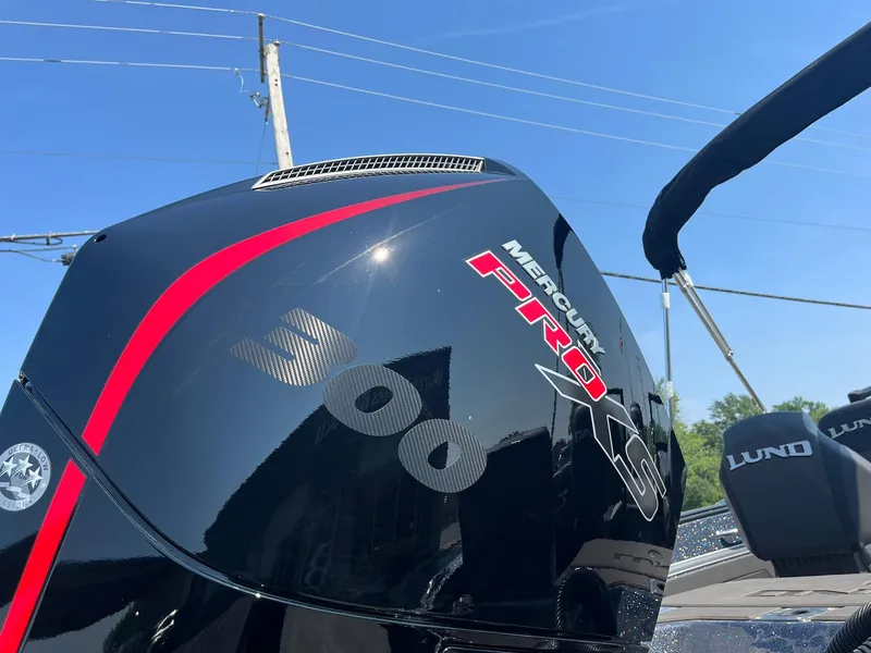 Slide: The Image of 2025 Lund 202 Pro-V GL boat with Mercury Pro XS 300 engine under clear blue sky. - 39