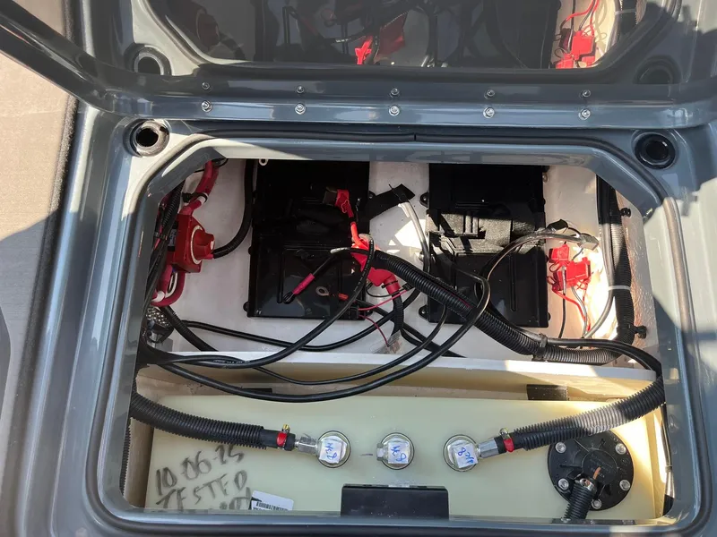 Slide: The Image of 2025 Lund 202 Pro-V GL boat battery compartment with wiring and components. - 41