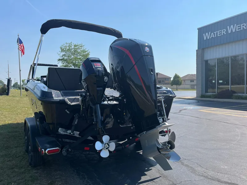 Slide: The Image of 2025 Lund 202 Pro-V GL boat with dual outboard motors at dealership. - 43