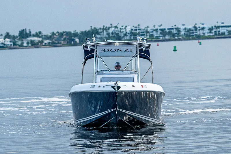 Slide: The Image of 2005 Donzi 32 ZF boat cruising on calm waters, front view. - 2