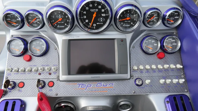 Slide: The Image of Dashboard of a 2005 Cigarette 39' Top Gun Unlimited boat with gauges and controls. - 13