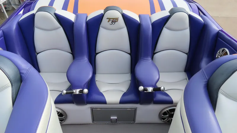 Slide: The Image of Luxurious seating in a 2005 Cigarette 39' Top Gun Unlimited boat, featuring blue and white upholstery. - 15
