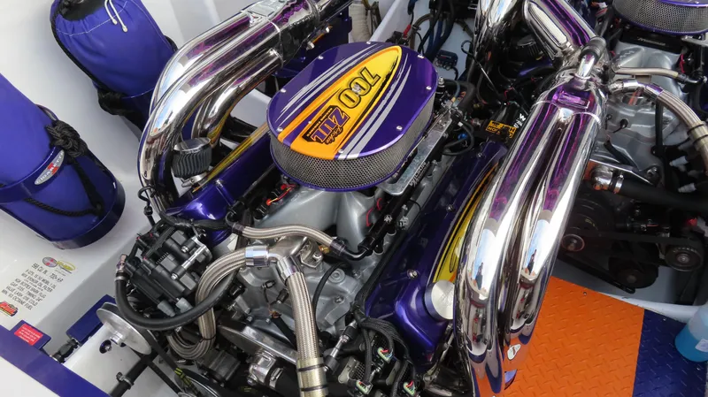 Slide: The Image of Engine of a 2005 Cigarette 39' Top Gun Unlimited boat, featuring vibrant purple accents. - 22