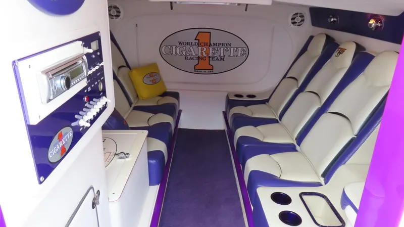 Slide: The Image of Interior of 2005 Cigarette 39' Top Gun Unlimited boat with plush seating and audio system. - 24