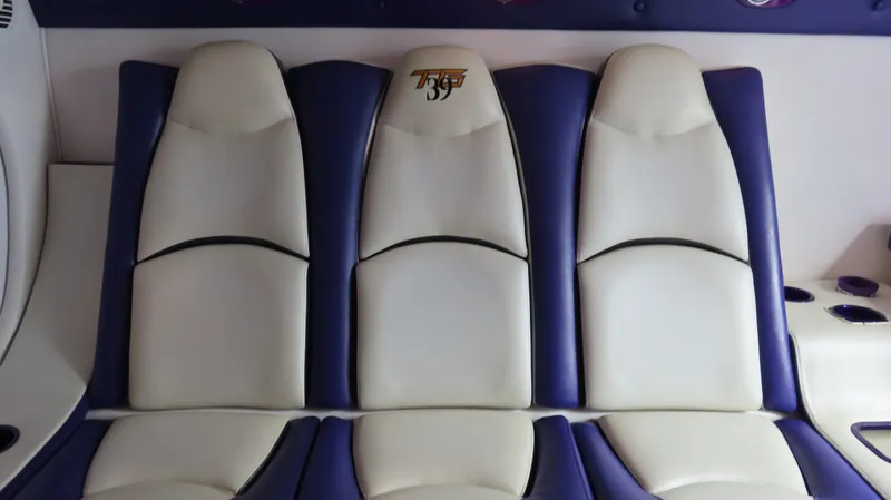 Slide: The Image of Interior seating of 2005 Cigarette 39' Top Gun Unlimited boat, featuring white and blue upholstery. - 27