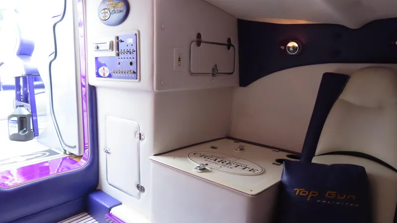 Slide: The Image of 2005 Cigarette 39' Top Gun Unlimited interior with purple accents and branded seating. - 30