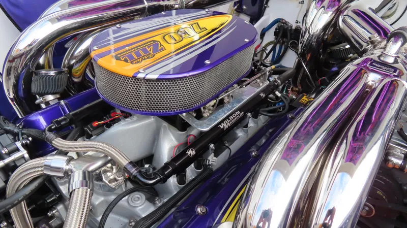 Slide: The Image of High-performance engine of 2005 Cigarette 39' Top Gun Unlimited boat, featuring vibrant purple accents. - 31