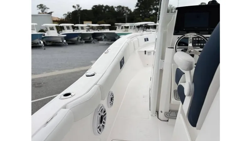 Slide: The Image of 2025 Sea Fox 288 Commander boat interior with steering wheel and seating, docked at marina. - 11