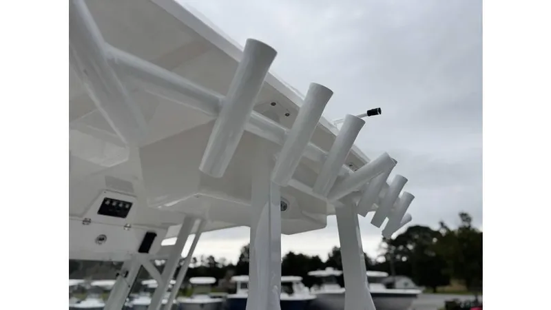 Slide: The Image of 2025 Sea Fox 288 Commander boat rod holders under cloudy sky. - 13