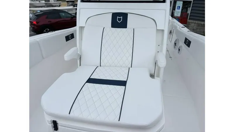 Slide: The Image of 2025 Sea Fox 288 Commander boat seat with white and navy diamond-patterned upholstery. - 16
