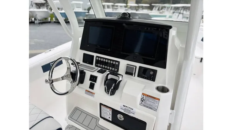 Slide: The Image of 2025 Sea Fox 288 Commander boat dashboard with steering wheel and control panels. - 7