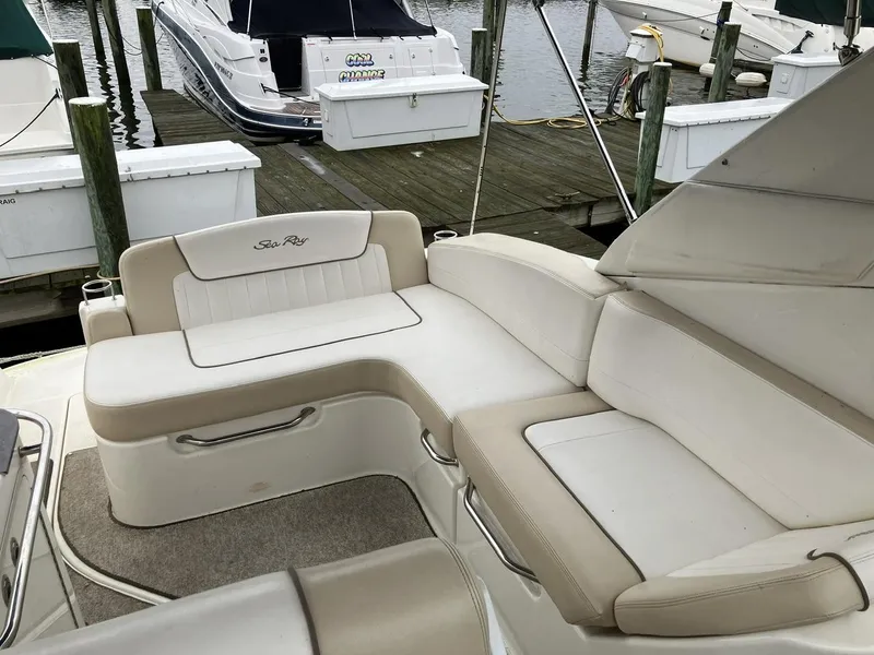 Slide: The Image of 2012 Sea Ray 280 Sundancer boat with beige seating at a marina dock. - 11