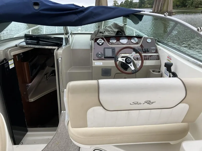 Slide: The Image of 2012 Sea Ray 280 Sundancer boat interior with helm and seating area. - 12