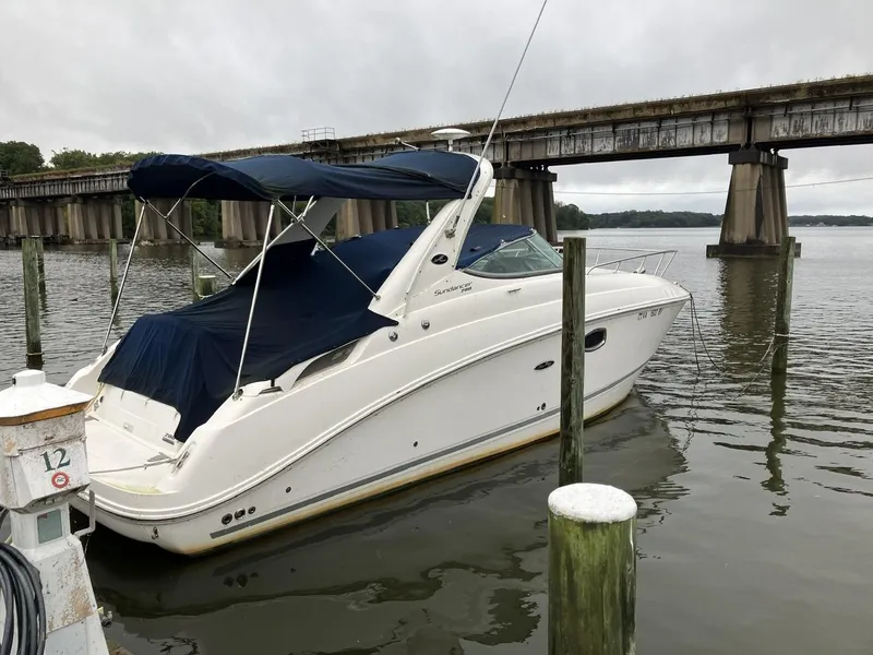 Slide: The Image of 2012 Sea Ray 280 Sundancer boat docked near a bridge on a cloudy day. - 3