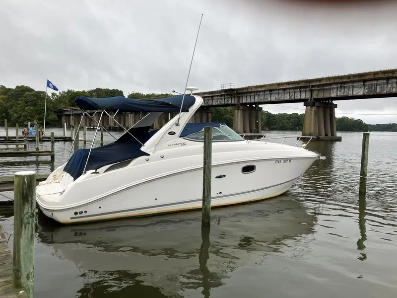 Slide: The Image of 2012 Sea Ray 280 Sundancer boat docked near a bridge on a cloudy day. - 4