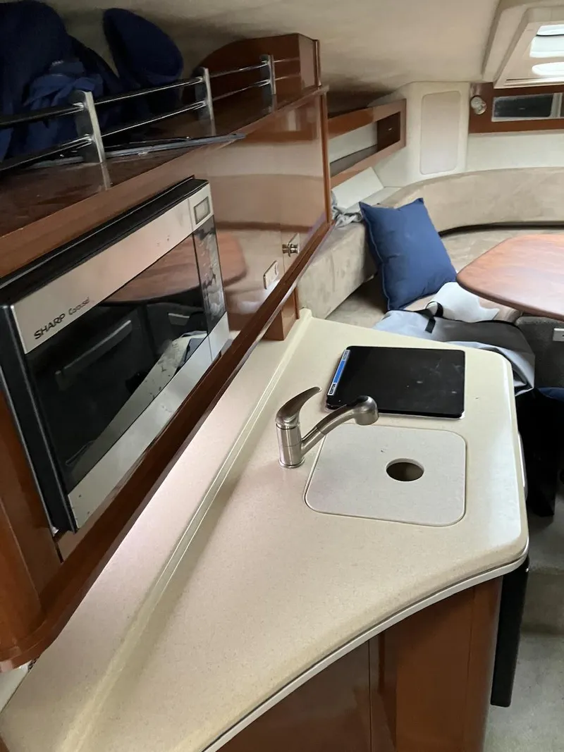 Slide: The Image of Interior of 2012 Sea Ray 280 Sundancer with kitchenette and seating area. - 8