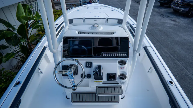 Slide: The Image of 2025 Tidewater 2300 Carolina Bay boat dashboard with steering wheel and controls. - 10