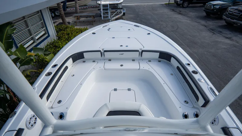 Slide: The Image of 2025 Tidewater 2300 Carolina Bay boat deck, featuring spacious seating and storage compartments. - 14
