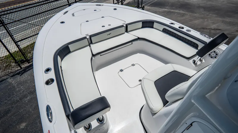 Slide: The Image of 2025 Tidewater 2300 Carolina Bay boat interior with cushioned seating and storage compartments. - 16