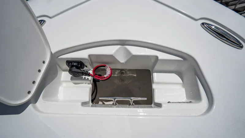 Slide: The Image of 2025 Tidewater 2300 Carolina Bay boat storage compartment with wiring and metal fittings. - 17