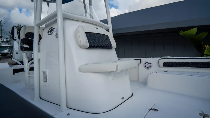 Slide: The Image of 2025 Tidewater 2300 Carolina Bay boat interior with cushioned seating and sleek design. - 21