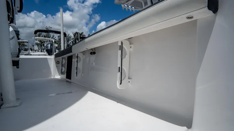 Slide: The Image of 2025 Tidewater 2300 Carolina Bay boat interior with sleek white design and storage features. - 23