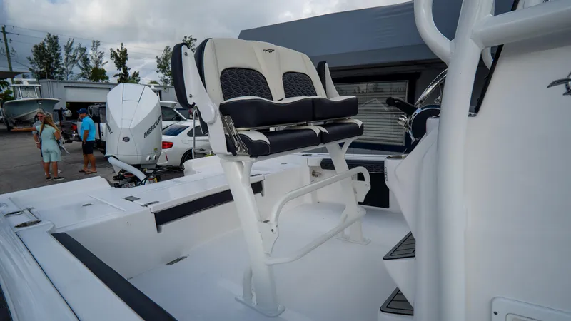 Slide: The Image of 2025 Tidewater 2300 Carolina Bay boat interior with seating and console. - 9
