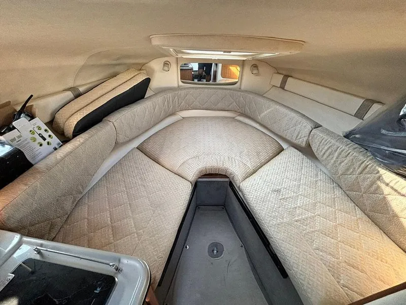 Slide: The Image of Interior cabin of 2006 Sea Ray 240 Sundancer with beige upholstery and compact design. - 18