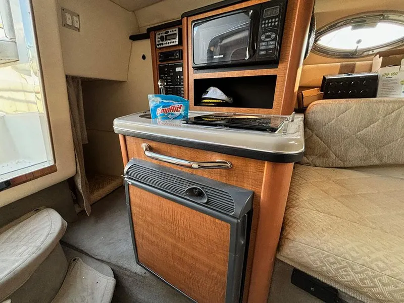 Slide: The Image of Interior of 2006 Sea Ray 240 Sundancer with kitchenette and seating area. - 19