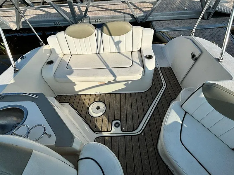 Slide: The Image of 2006 Sea Ray 240 Sundancer boat interior with seating and wood flooring. - 5