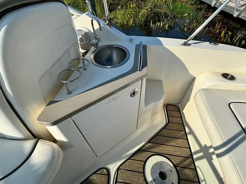 Slide: The Image of 2006 Sea Ray 240 Sundancer boat interior with sink and cup holders. - 6