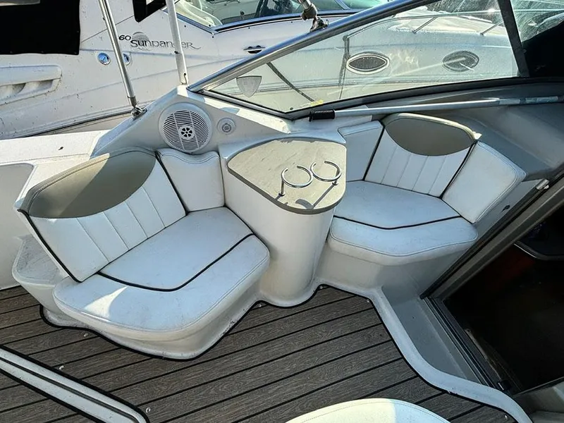 Slide: The Image of 2006 Sea Ray 240 Sundancer boat interior with white seating and cup holders. - 8