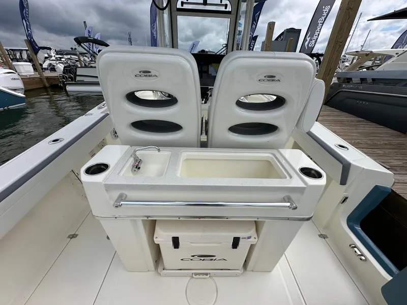 Slide: The Image of 2025 Cobia 265 CC boat interior with dual seats and fishing station. - 4