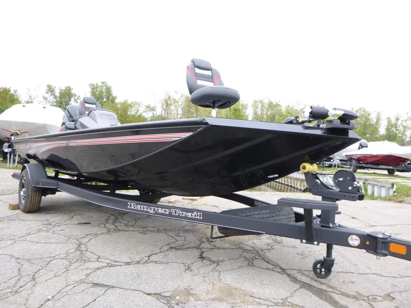 Slide: The Image of 2024 Ranger RT188 boat on trailer, black exterior, parked outdoors. - 1