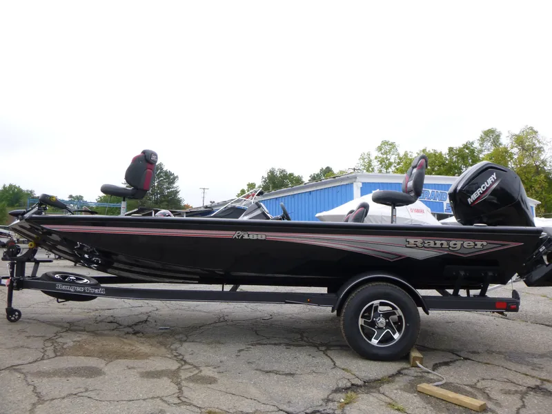 Slide: The Image of 2024 Ranger RT188 boat with Mercury engine on trailer, parked outdoors. - 2