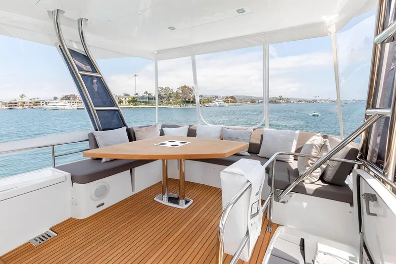 Slide: The Image of Luxurious 2016 Prestige 550 yacht interior with elegant seating and scenic ocean view. - 10