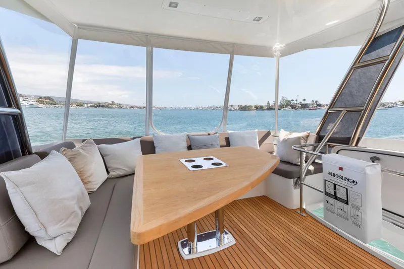 Slide: The Image of Luxurious 2016 Prestige 550 yacht interior with elegant seating and scenic ocean view. - 11