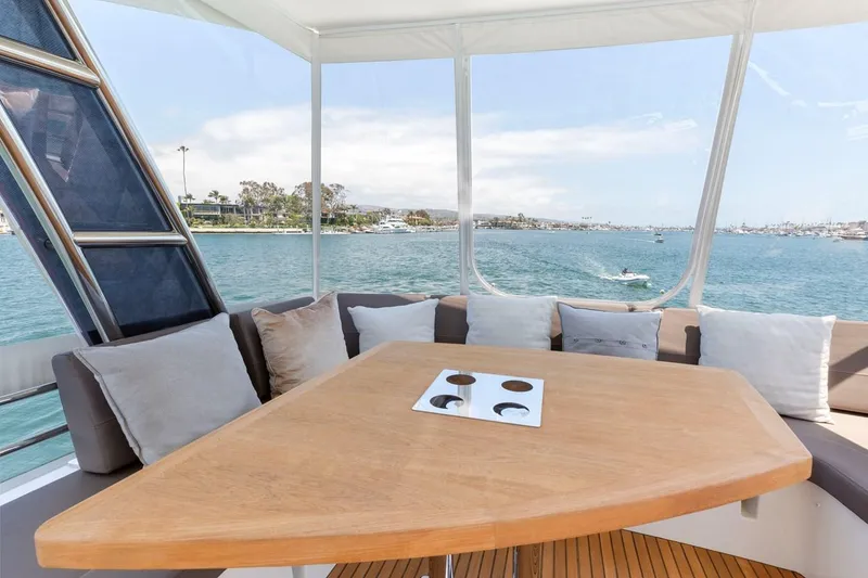 Slide: The Image of Luxurious 2016 Prestige 550 yacht interior with scenic ocean view and comfortable seating. - 12