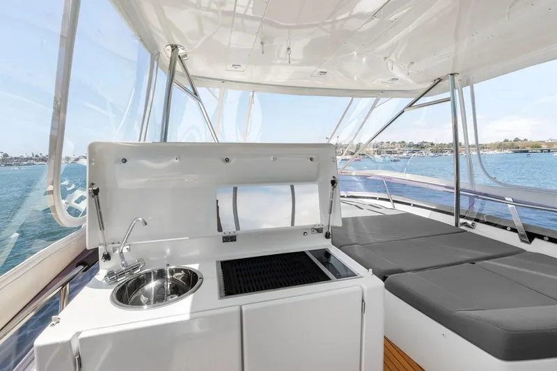 Slide: The Image of Luxury yacht Prestige 550, 2016 model, featuring outdoor kitchenette and sunbathing area. - 14