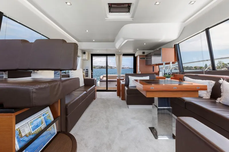 Slide: The Image of Luxurious interior of 2016 Prestige 550 yacht with modern furnishings and panoramic windows. - 21